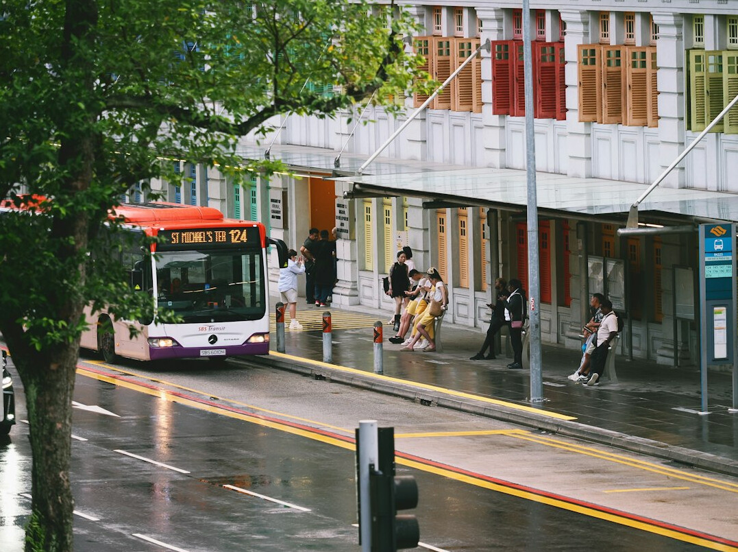 People waiting for a public bus at a city bus stop